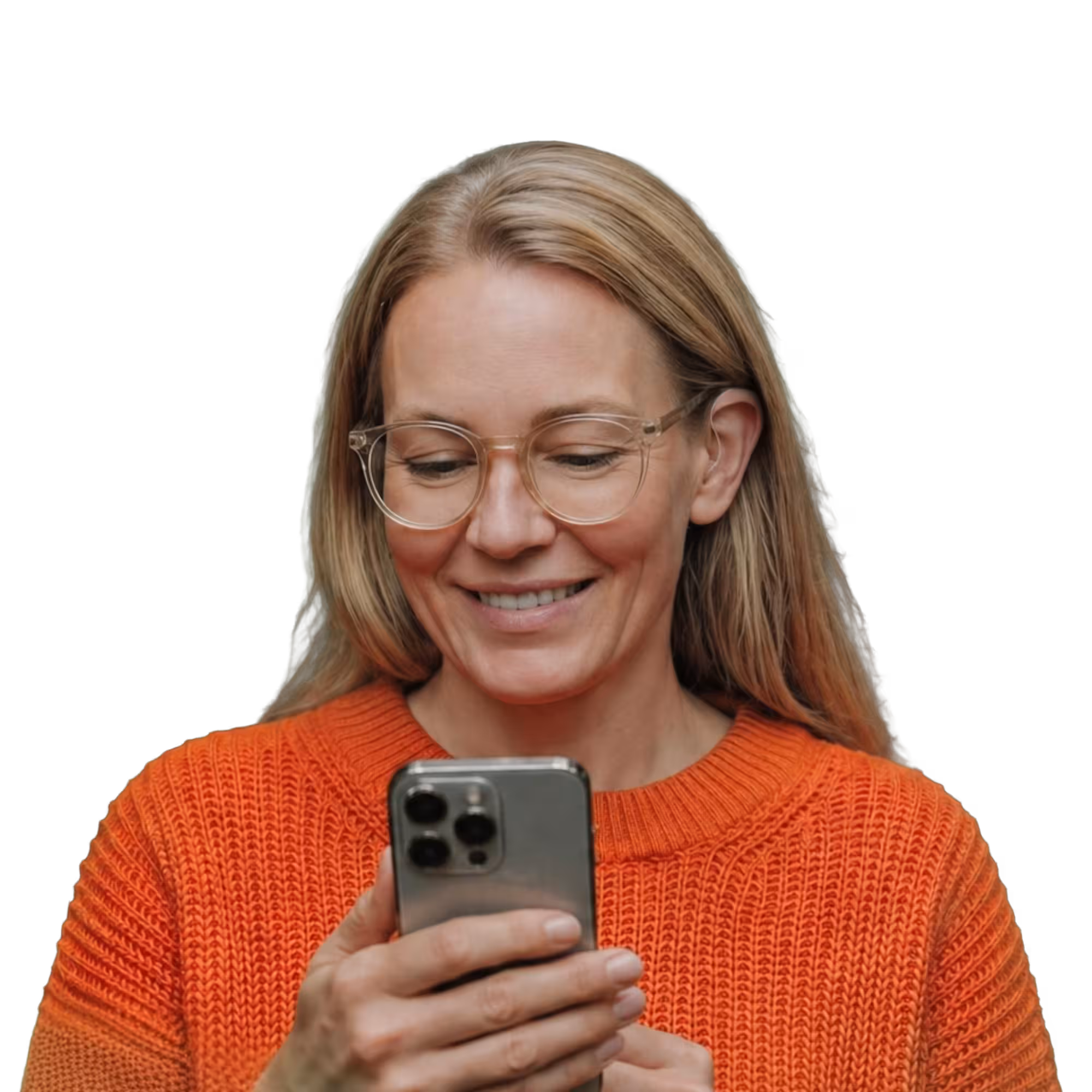 Smiling woman in an orange knit sweater and clear-framed glasses, reading captions on her phone.
