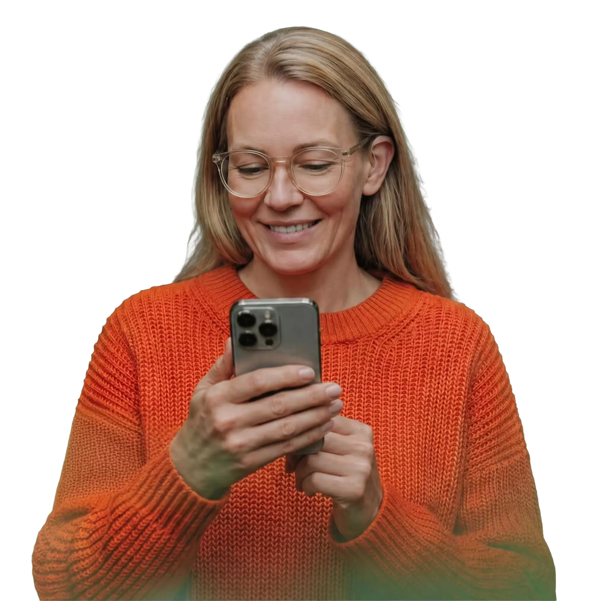 Smiling woman wearing glasses and an orange sweater, holding a smartphone in a forest setting.